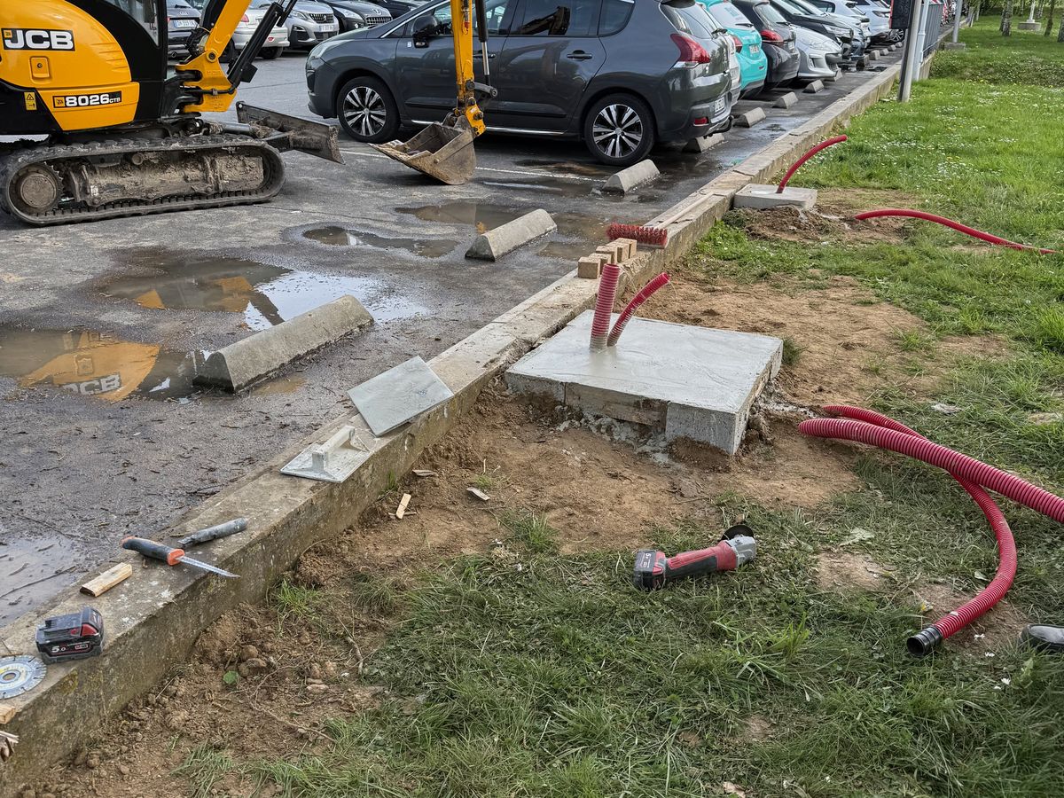 Tranchée et socle de borne de recharge en cours de travaux